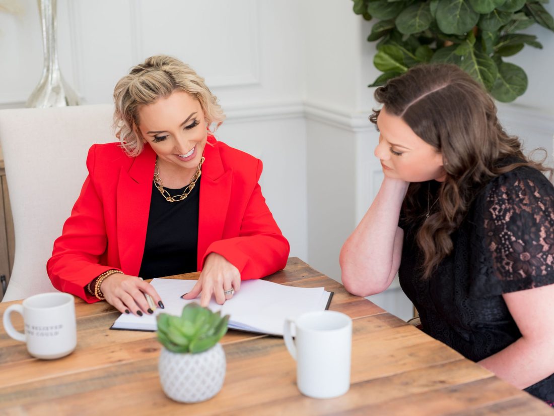 Two colleagues reviewing plans together at a table