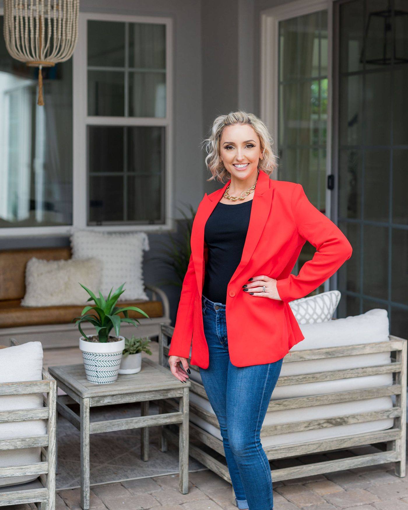 Glynis Shulters standing, in a red blazer